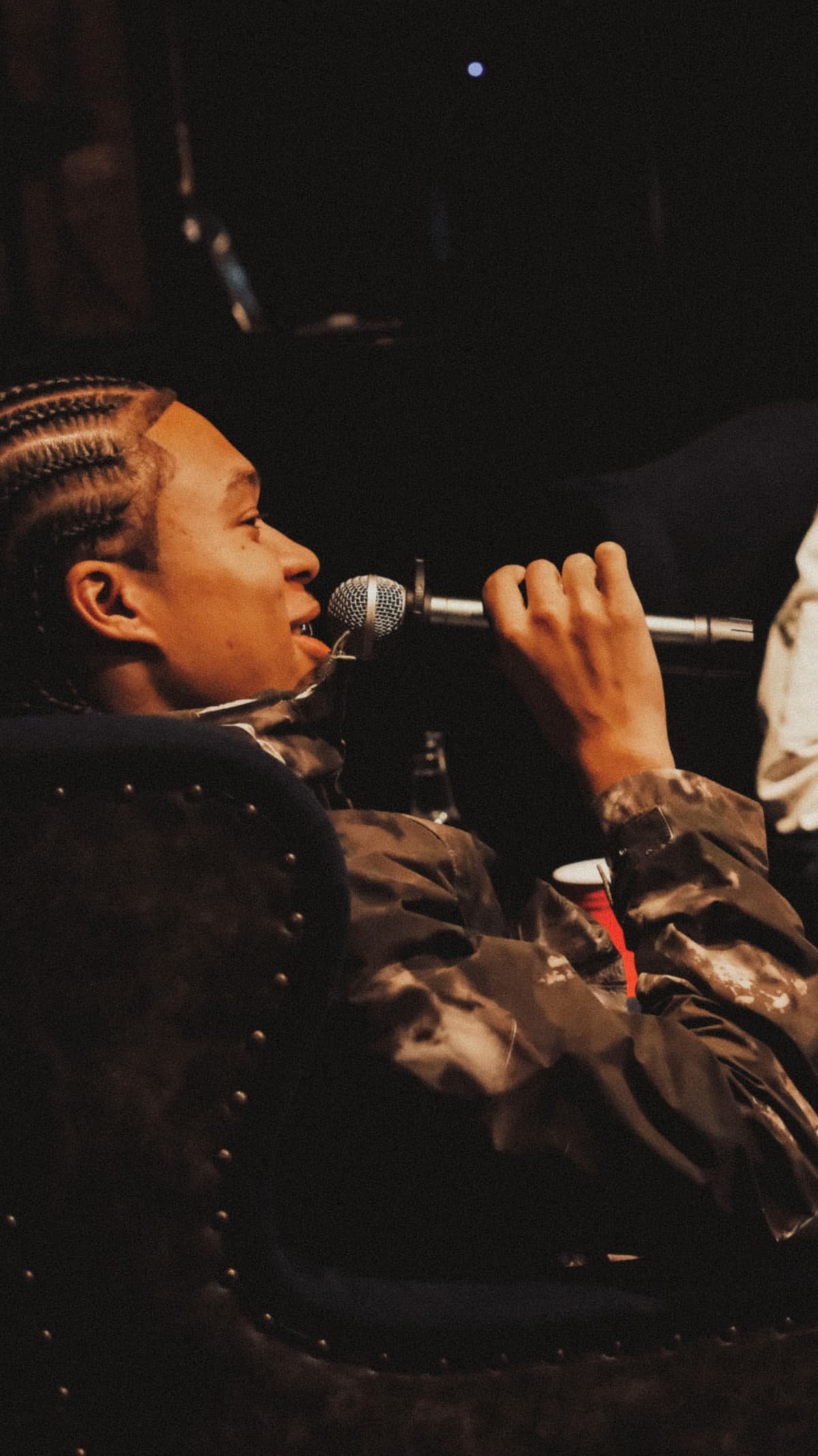 Nippa speaking into a microphone during the Homegrown listening party in Shoreditch, London
